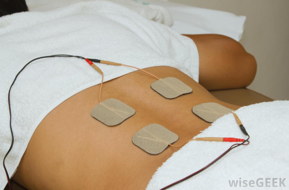 Patient applying electrical stimulation therapy on back. Electri - Warner  Orthopedics